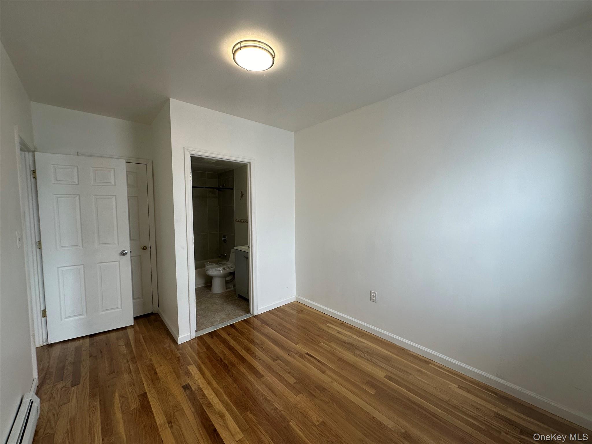 85-45 Britton Avenue Queens, NY 11373 - Photo 14 of 19 a view of room with wooden floor and closet