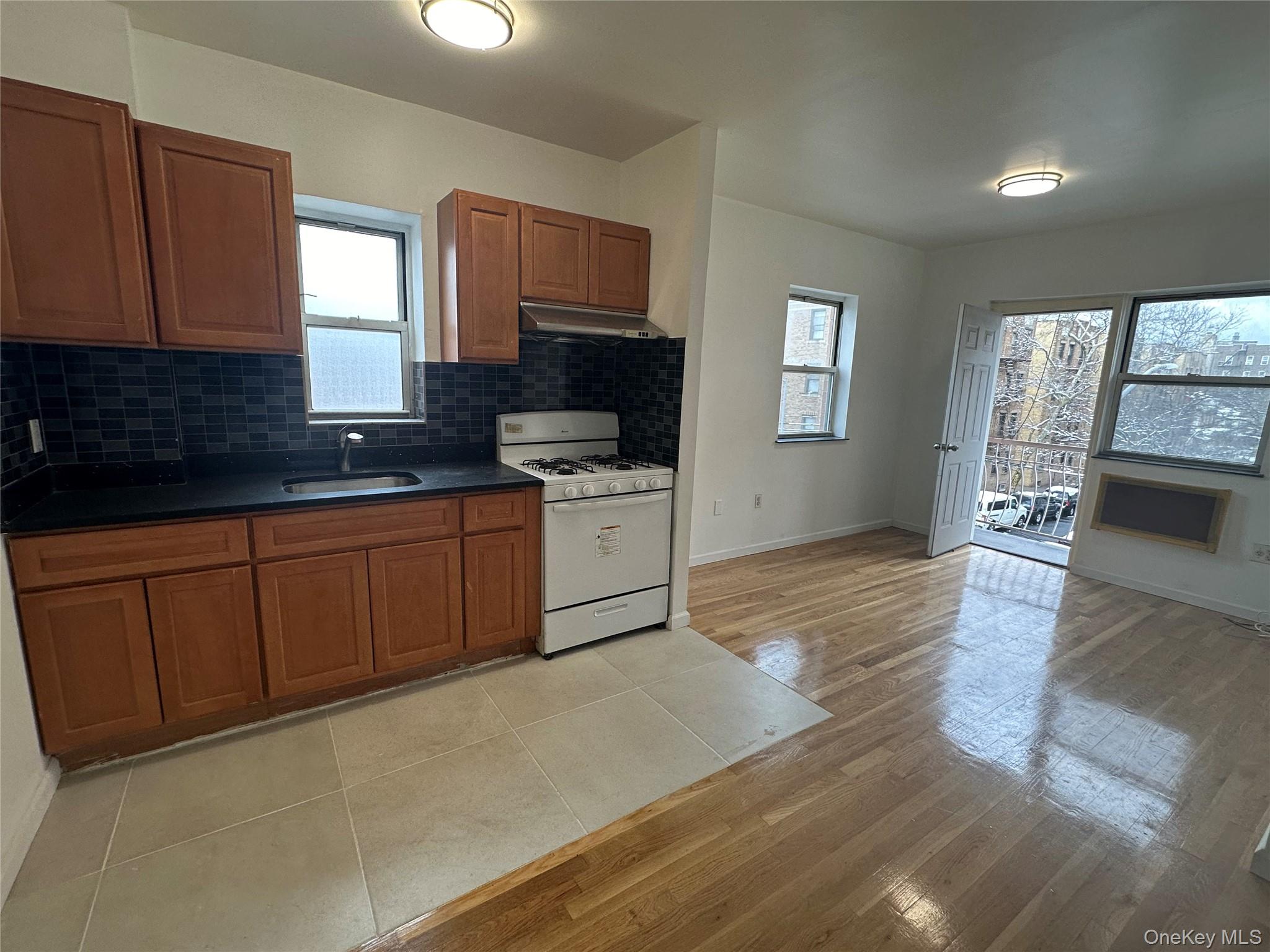 85-45 Britton Avenue Queens, NY 11373 - Photo 10 of 19 a kitchen with stainless steel appliances granite countertop a stove a sink and a microwave
