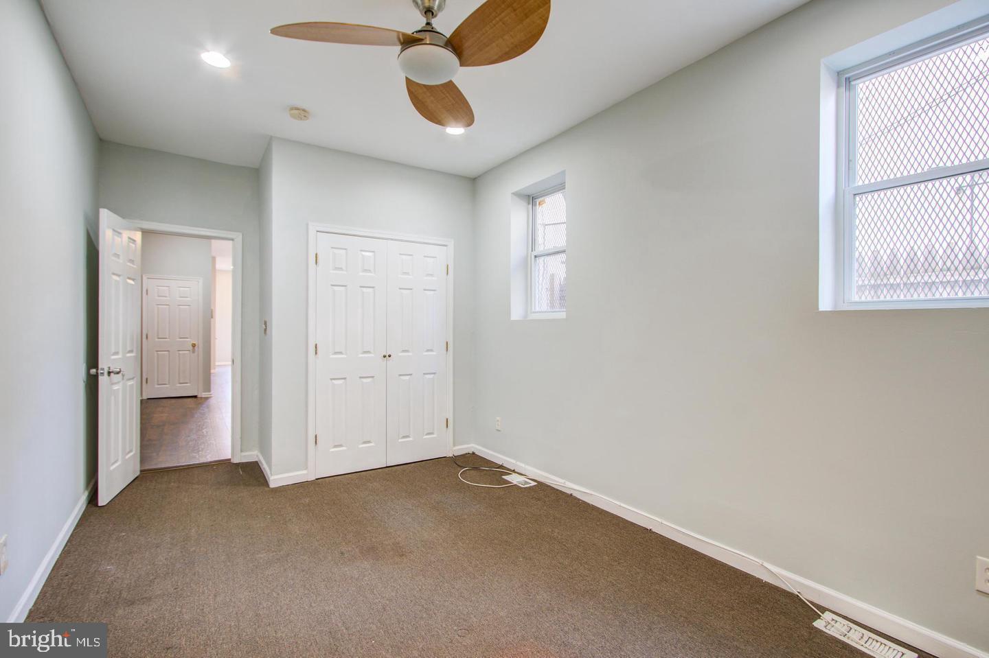 604 North Fulton Avenue Baltimore, MD 21217 - Photo 12 of 29 en empty room with windows and ceiling fan