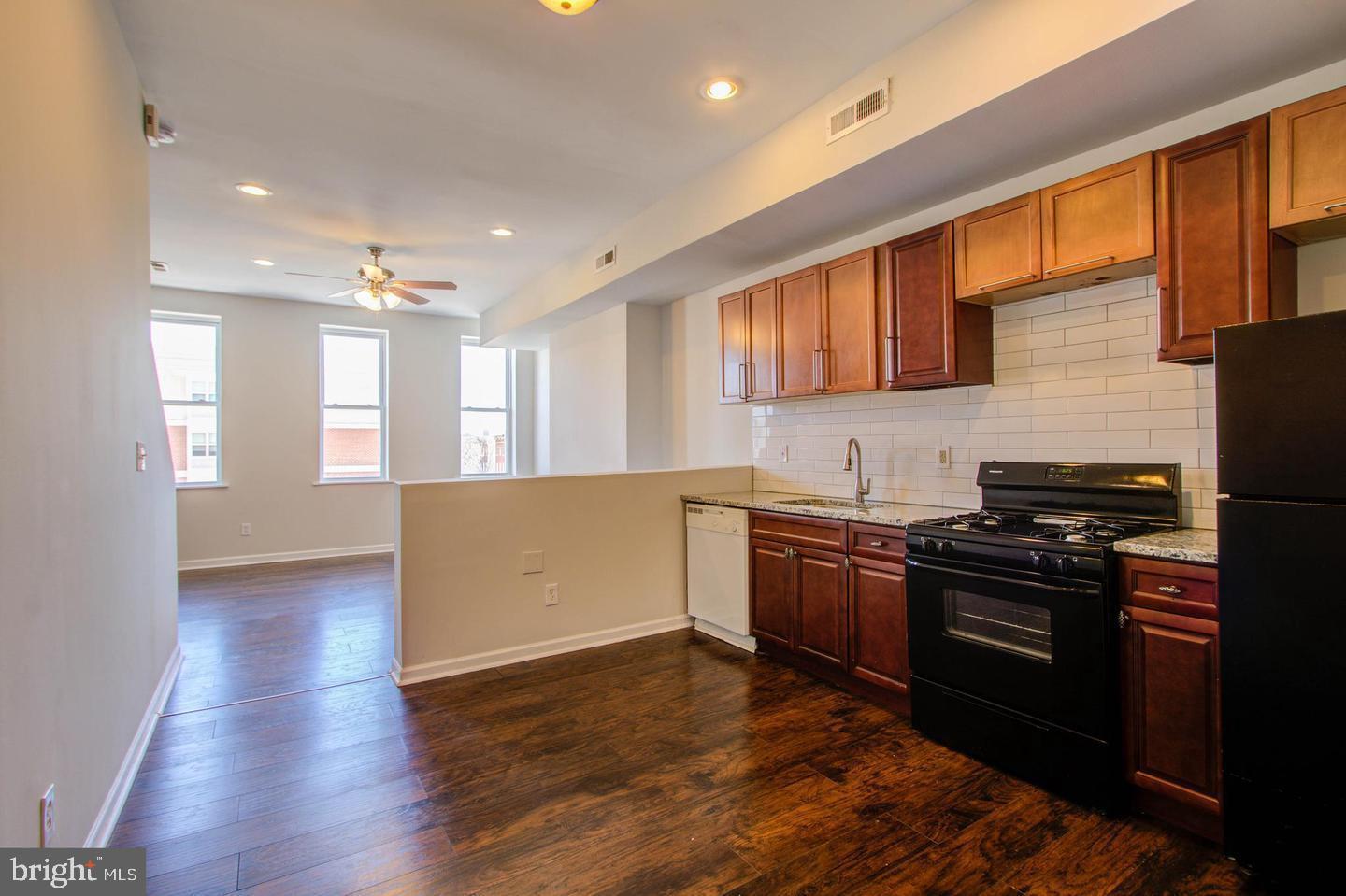 604 North Fulton Avenue Baltimore, MD 21217 - Photo 19 of 29 a kitchen with stainless steel appliances granite countertop a stove and a refrigerator