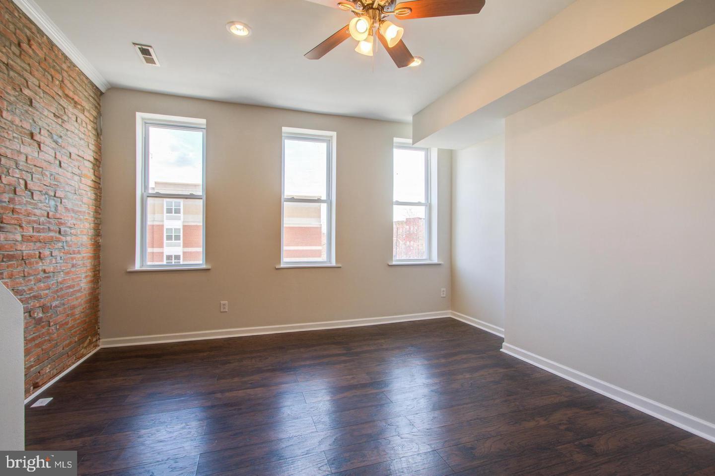 604 North Fulton Avenue Baltimore, MD 21217 - Photo 21 of 29 an empty room with wooden floor and windows