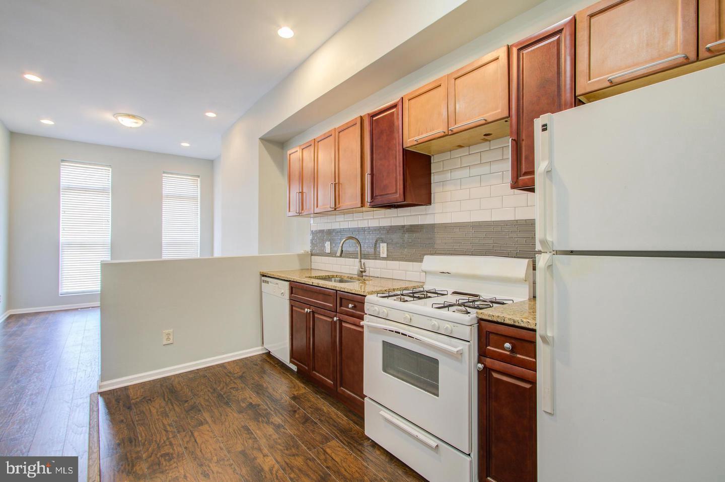 604 North Fulton Avenue Baltimore, MD 21217 - Photo 6 of 29 a kitchen with stainless steel appliances granite countertop a stove a sink and a refrigerator