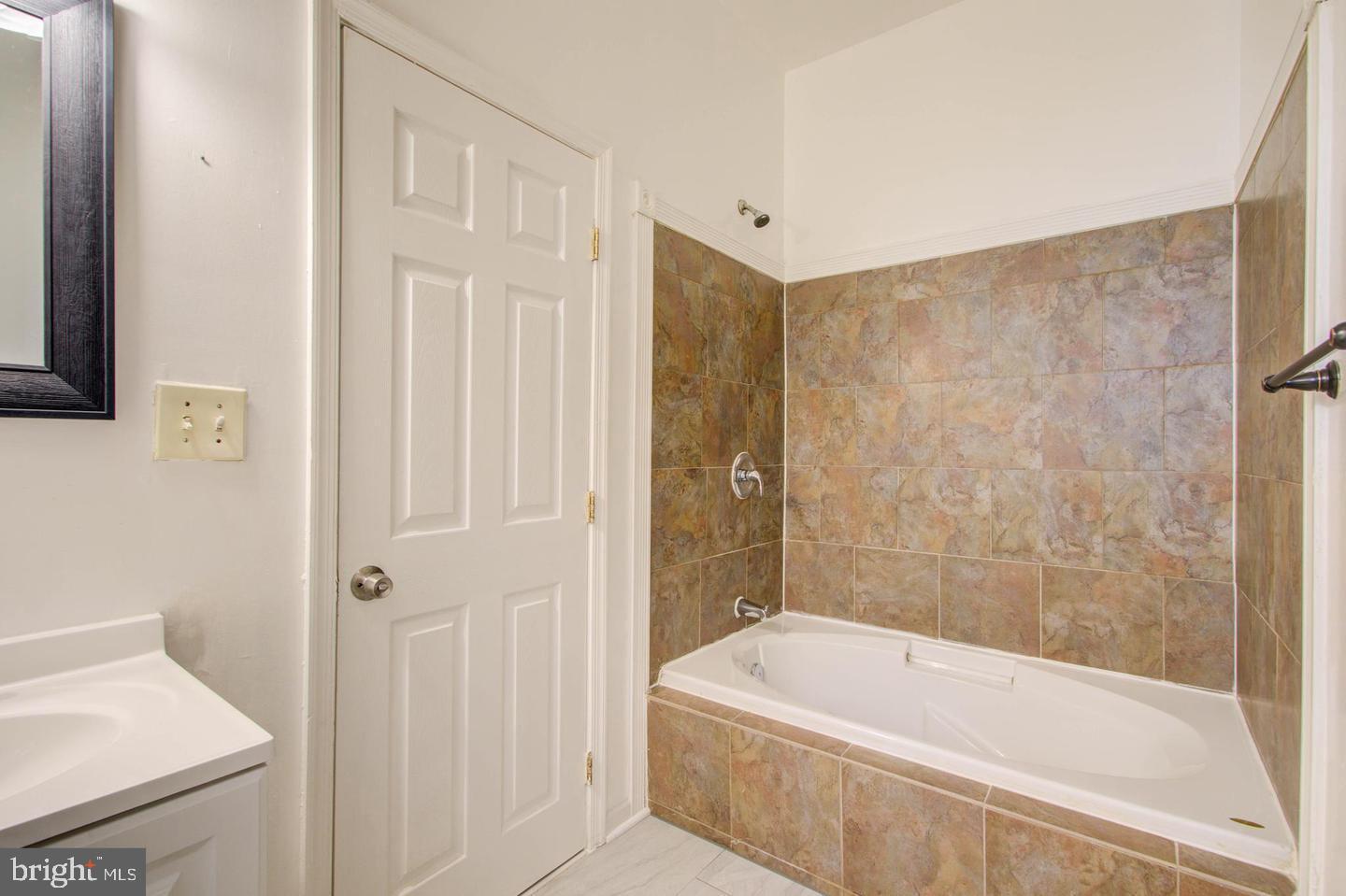 604 North Fulton Avenue Baltimore, MD 21217 - Photo 10 of 29 a bathroom with a tub shower and sink