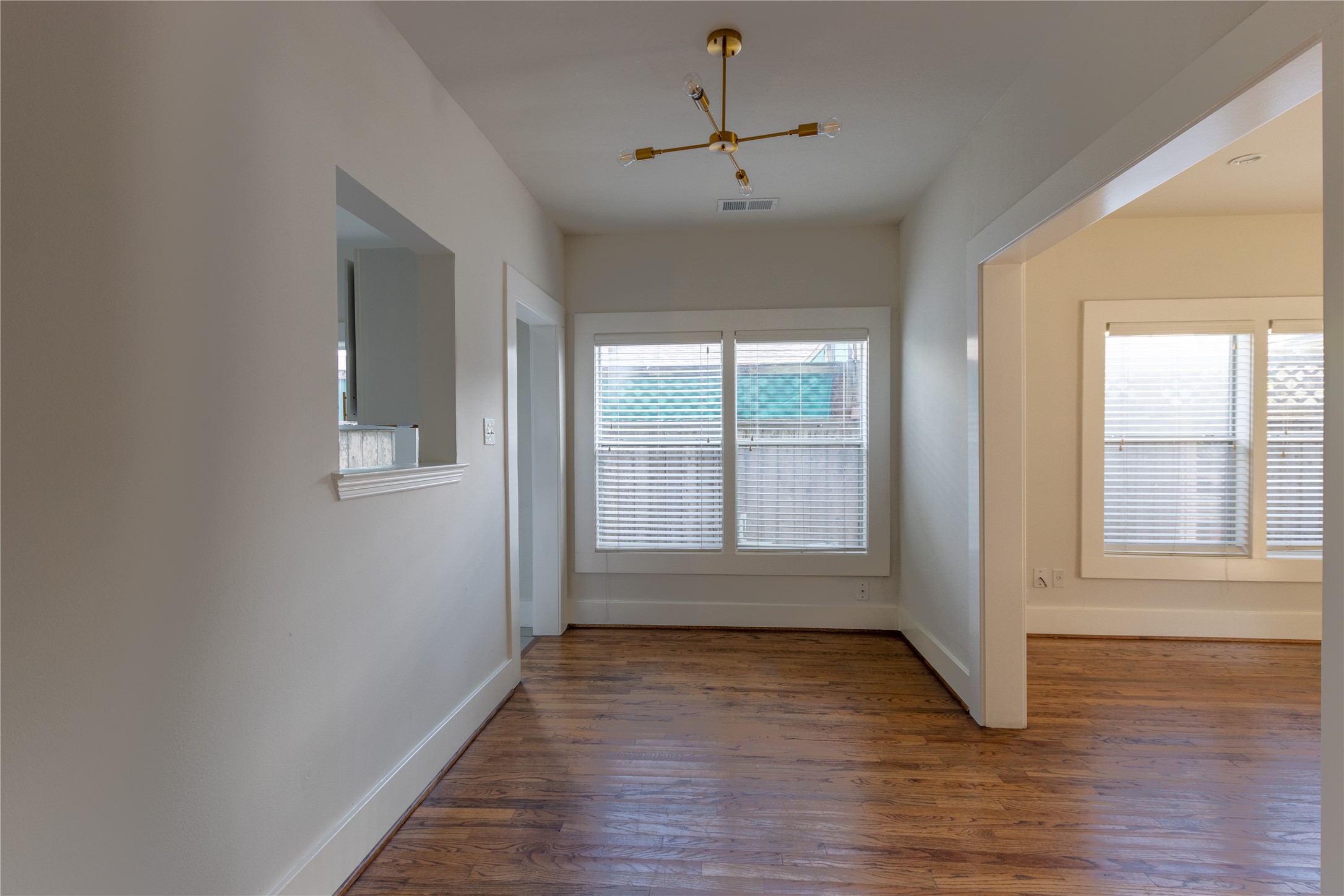 2009 Singleton Street Houston, TX 77008 - Photo 10 of 24 a view of an empty room with wooden floor and a window
