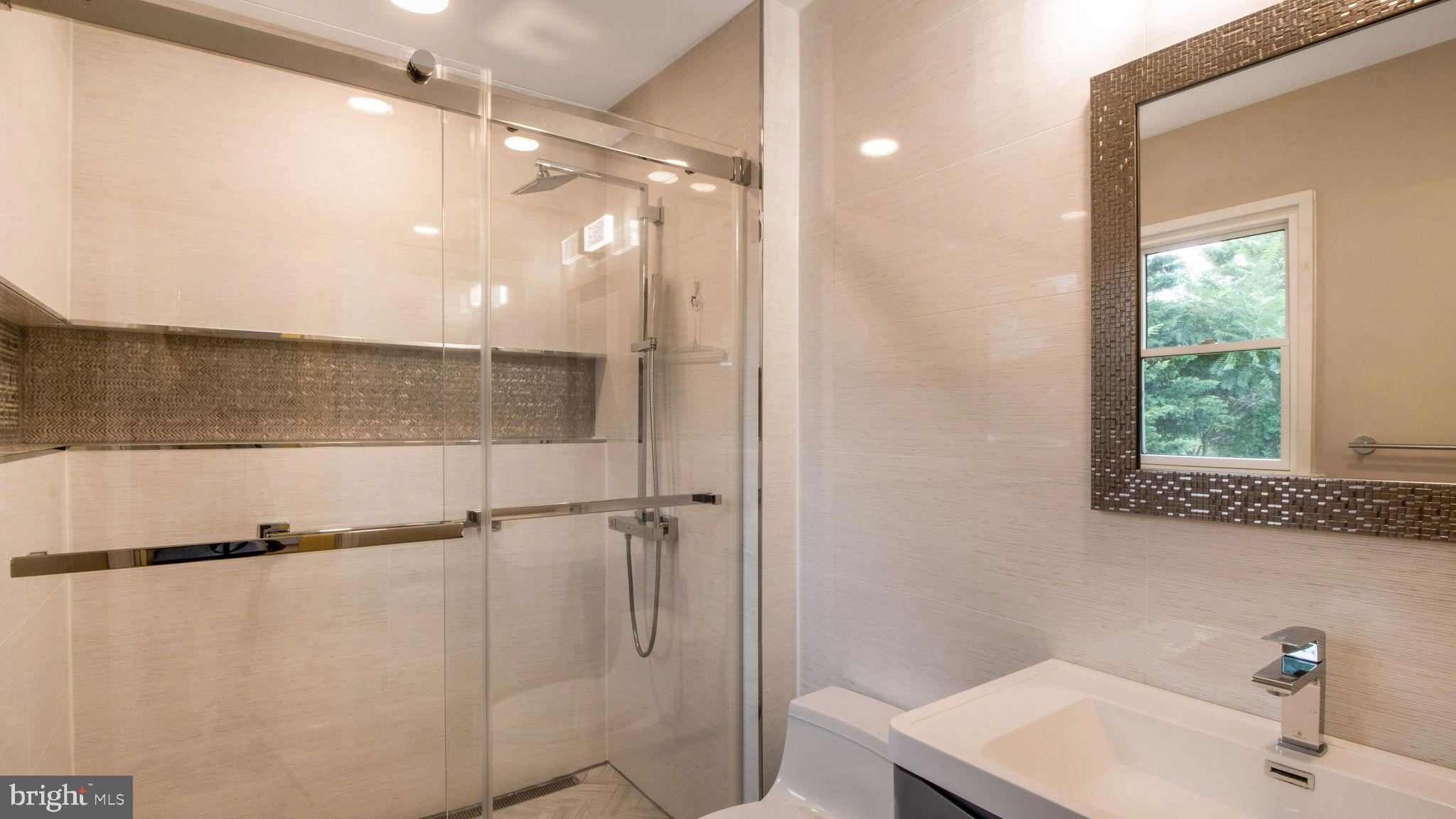 8933 Colesville Road Silver Spring, MD 20910 - Photo 16 of 31 a bathroom with a sink and a mirror