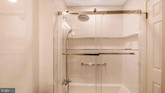 a bathroom with a glass shower door