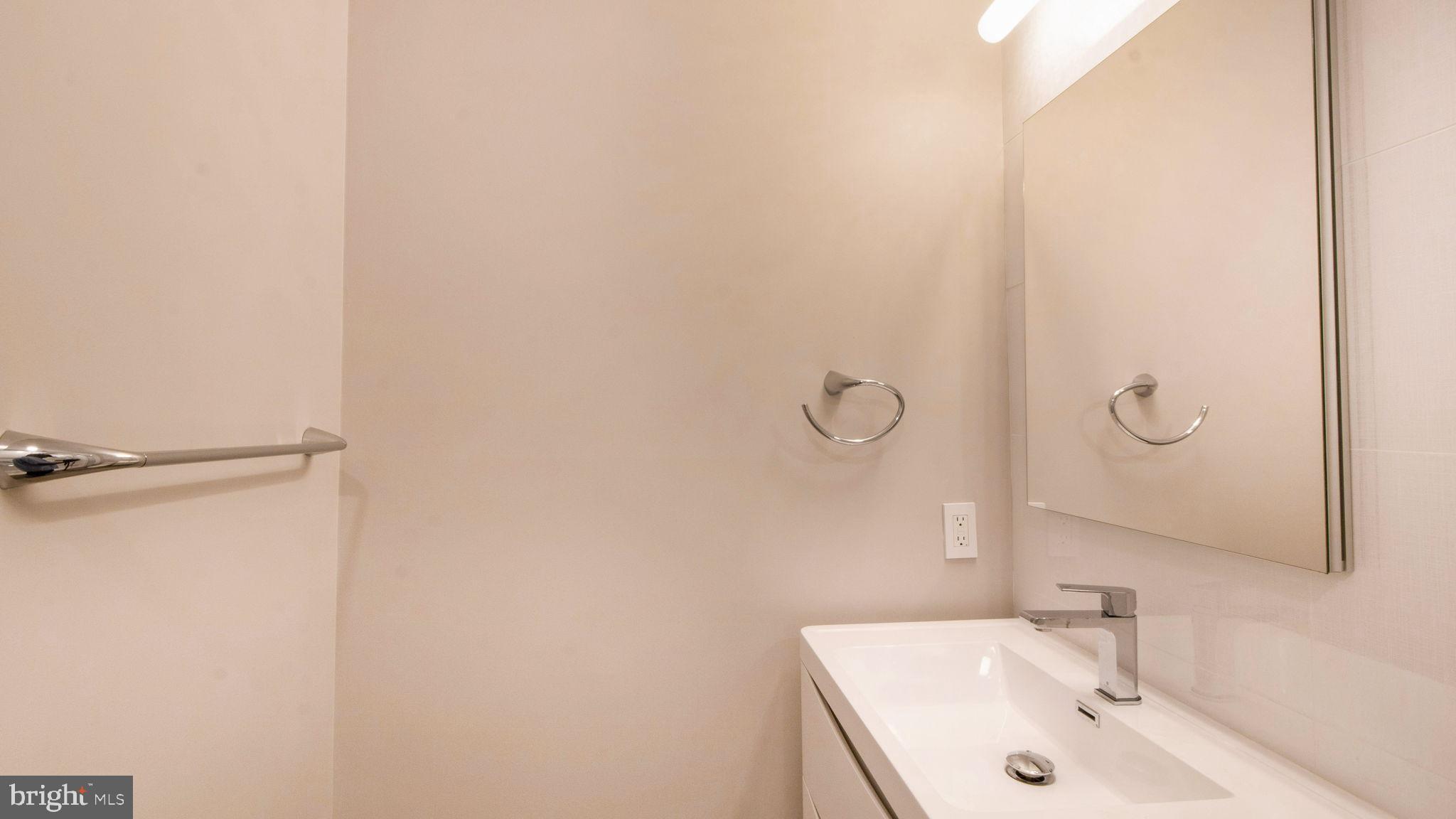 8933 Colesville Road Silver Spring, MD 20910 - Photo 24 of 31 a bathroom with a sink and mirror