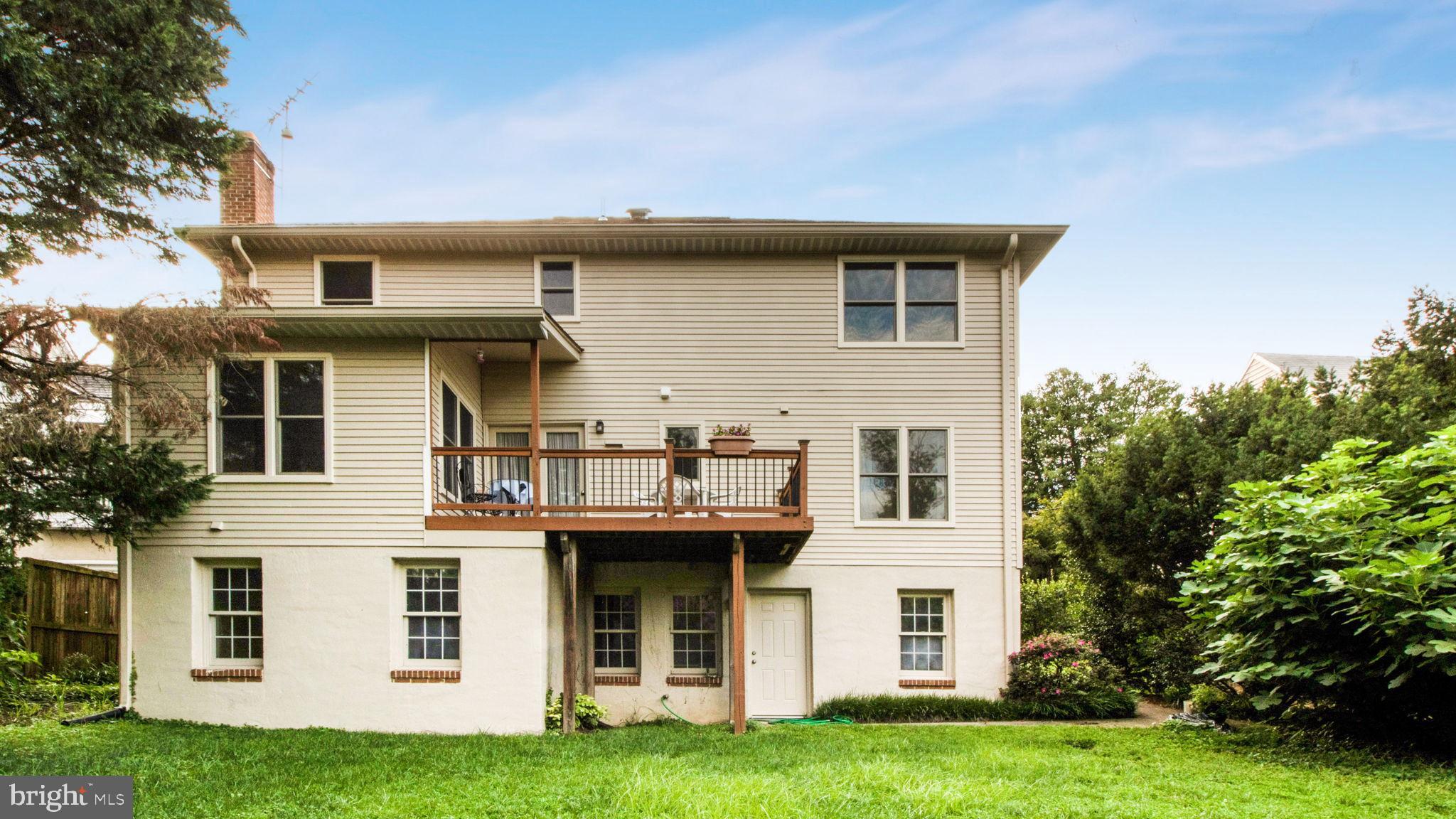 8933 Colesville Road Silver Spring, MD 20910 - Photo 28 of 31 a view of a white house with a big yard and large trees