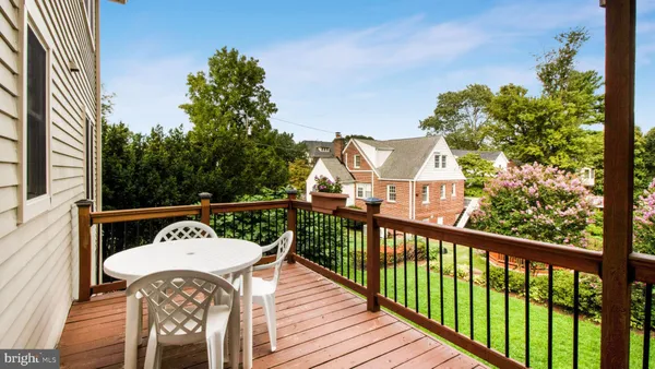 a view of a balcony with wooden floor and outdoor seating