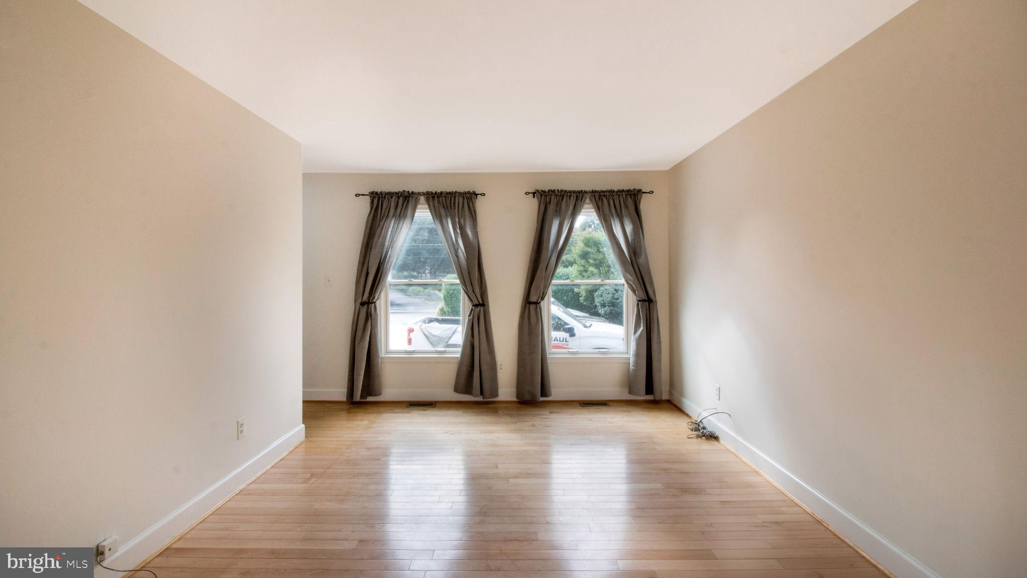 8933 Colesville Road Silver Spring, MD 20910 - Photo 8 of 31 an empty room with wooden floor and windows