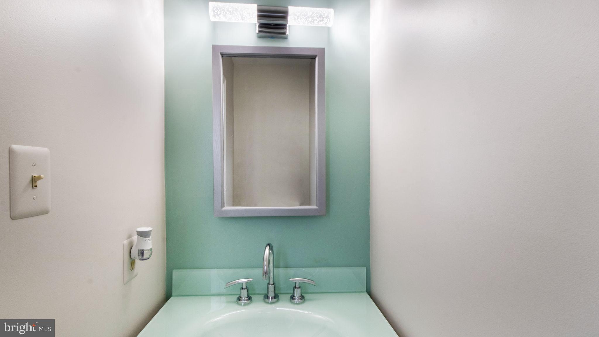 8933 Colesville Road Silver Spring, MD 20910 - Photo 10 of 31 a bathroom with a sink and a mirror