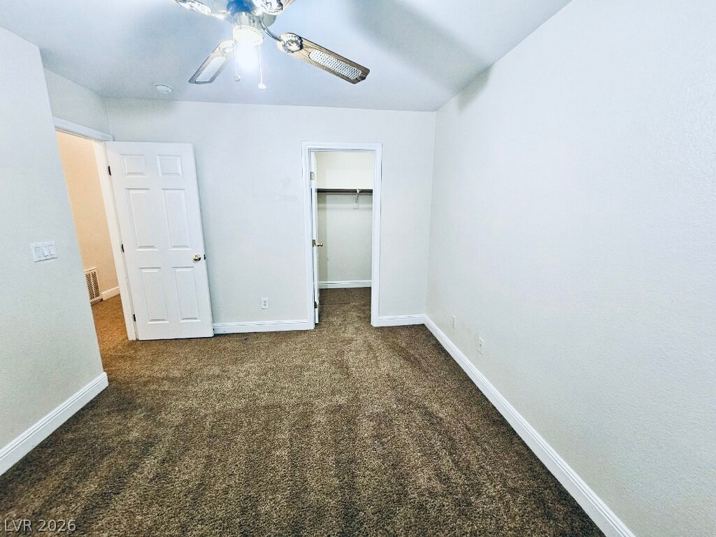 5953 Crumbling Ridge Street Henderson, NV 89011 - Photo 33 of 42 A well-proportioned bedroom offers comfort with plush carpeting and a convenient closet.