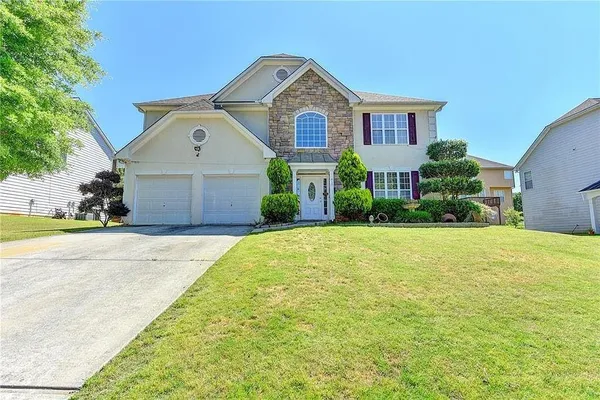 a front view of a house with a yard