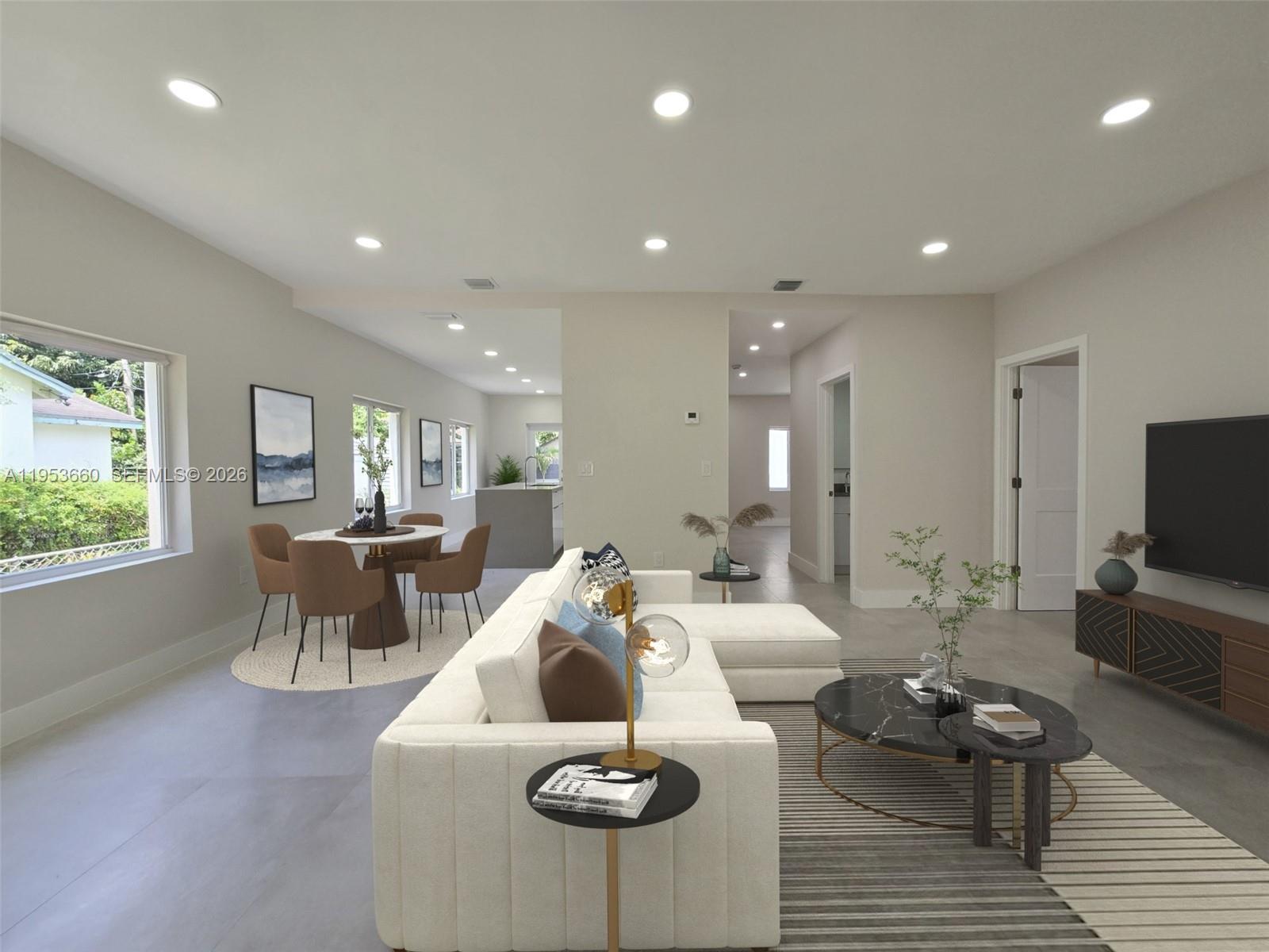 765 Northwest 45th Street Miami, FL 33127 - Photo 12 of 46 a living room with furniture and a flat screen tv