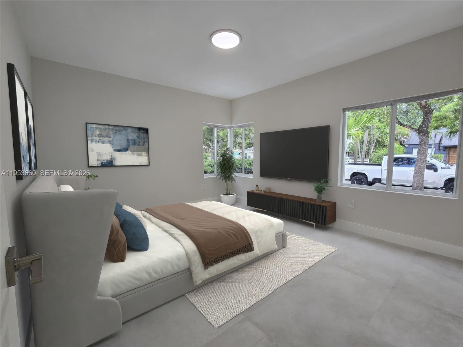 765 Northwest 45th Street Miami, FL 33127 - Photo 16 of 46 a bedroom with a bed and a flat screen tv