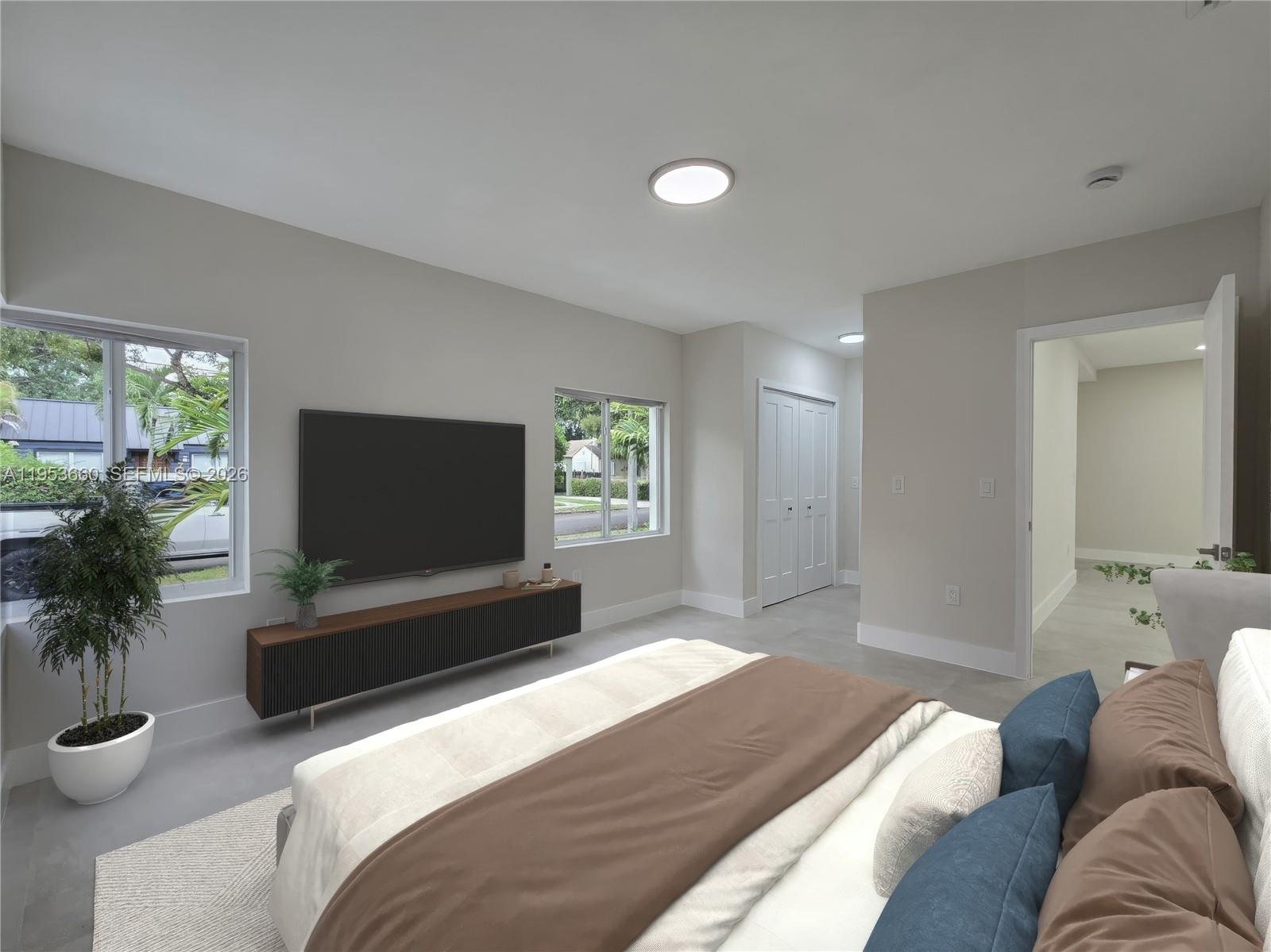 765 Northwest 45th Street Miami, FL 33127 - Photo 17 of 46 a bedroom with furniture and a flat screen tv