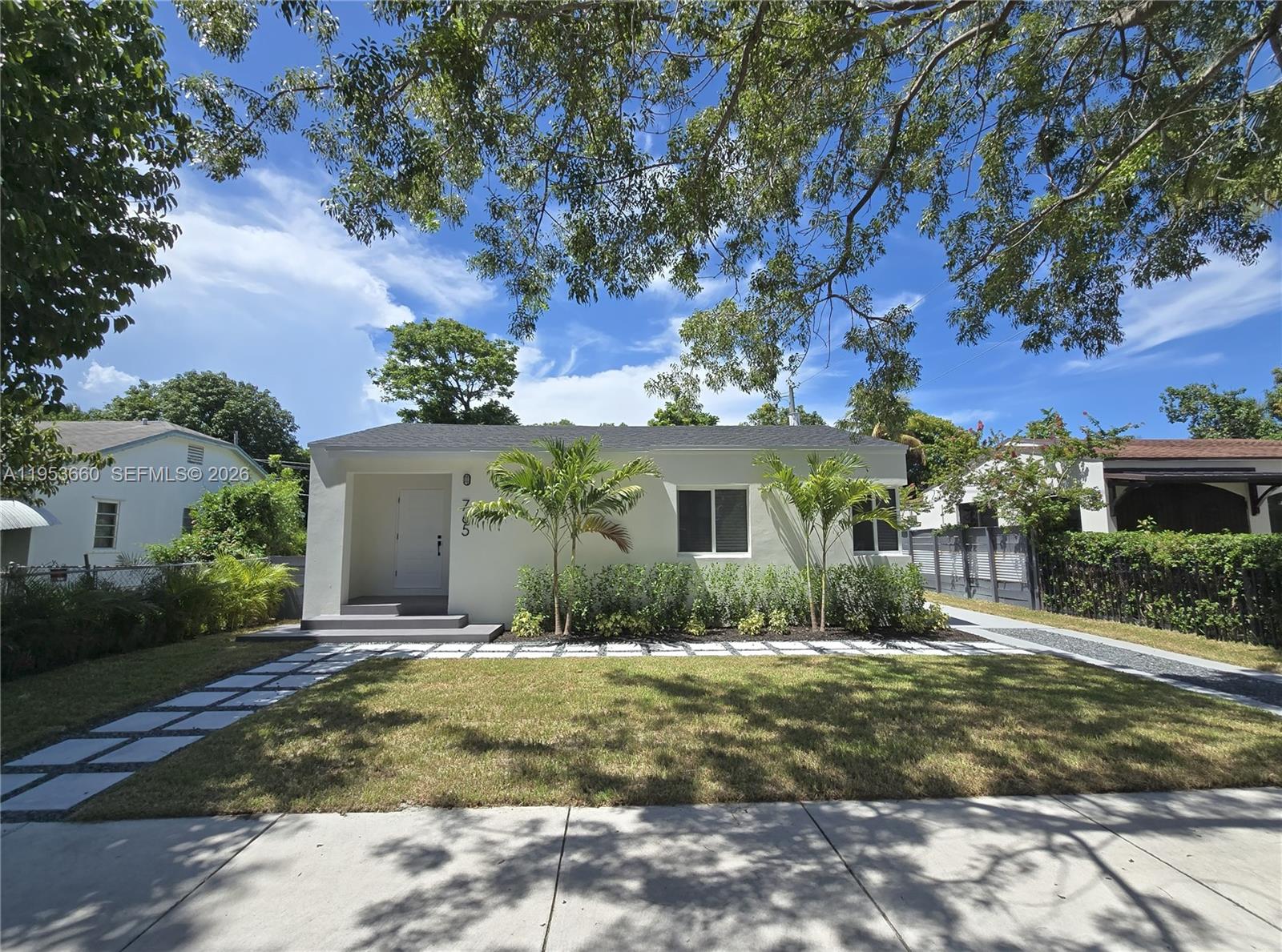 765 Northwest 45th Street Miami, FL 33127 - Photo 2 of 46 a front view of a house with a yard