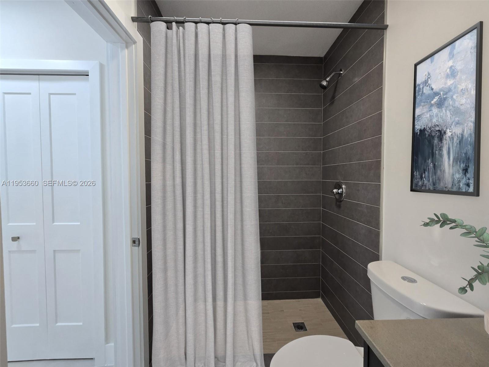 765 Northwest 45th Street Miami, FL 33127 - Photo 22 of 46 a bathroom with a toilet and a shower