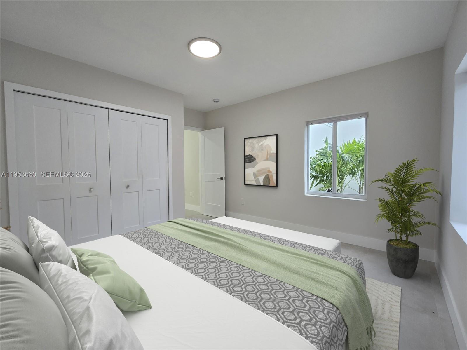 765 Northwest 45th Street Miami, FL 33127 - Photo 26 of 46 a bedroom with a bed and a potted plant