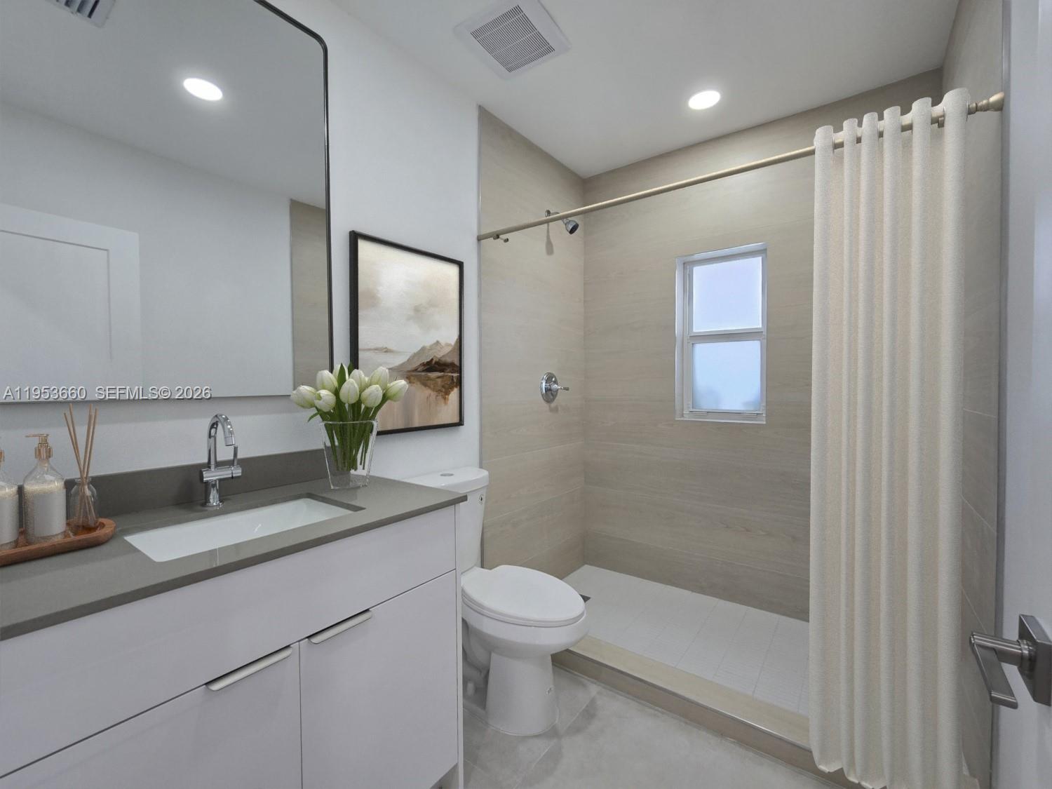 765 Northwest 45th Street Miami, FL 33127 - Photo 31 of 46 a bathroom with a granite countertop sink a toilet and shower