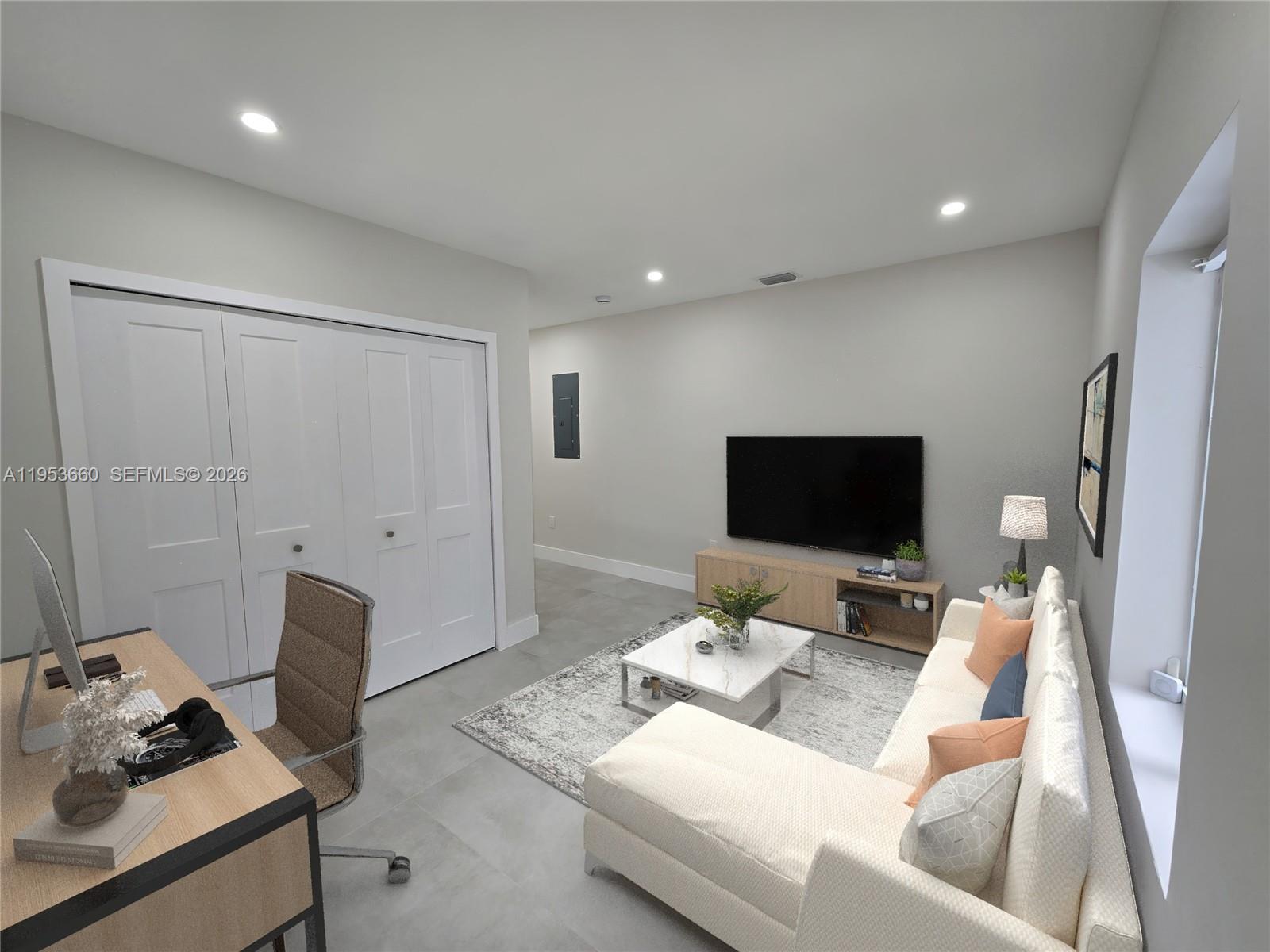 765 Northwest 45th Street Miami, FL 33127 - Photo 34 of 46 a living room with furniture and a flat screen tv