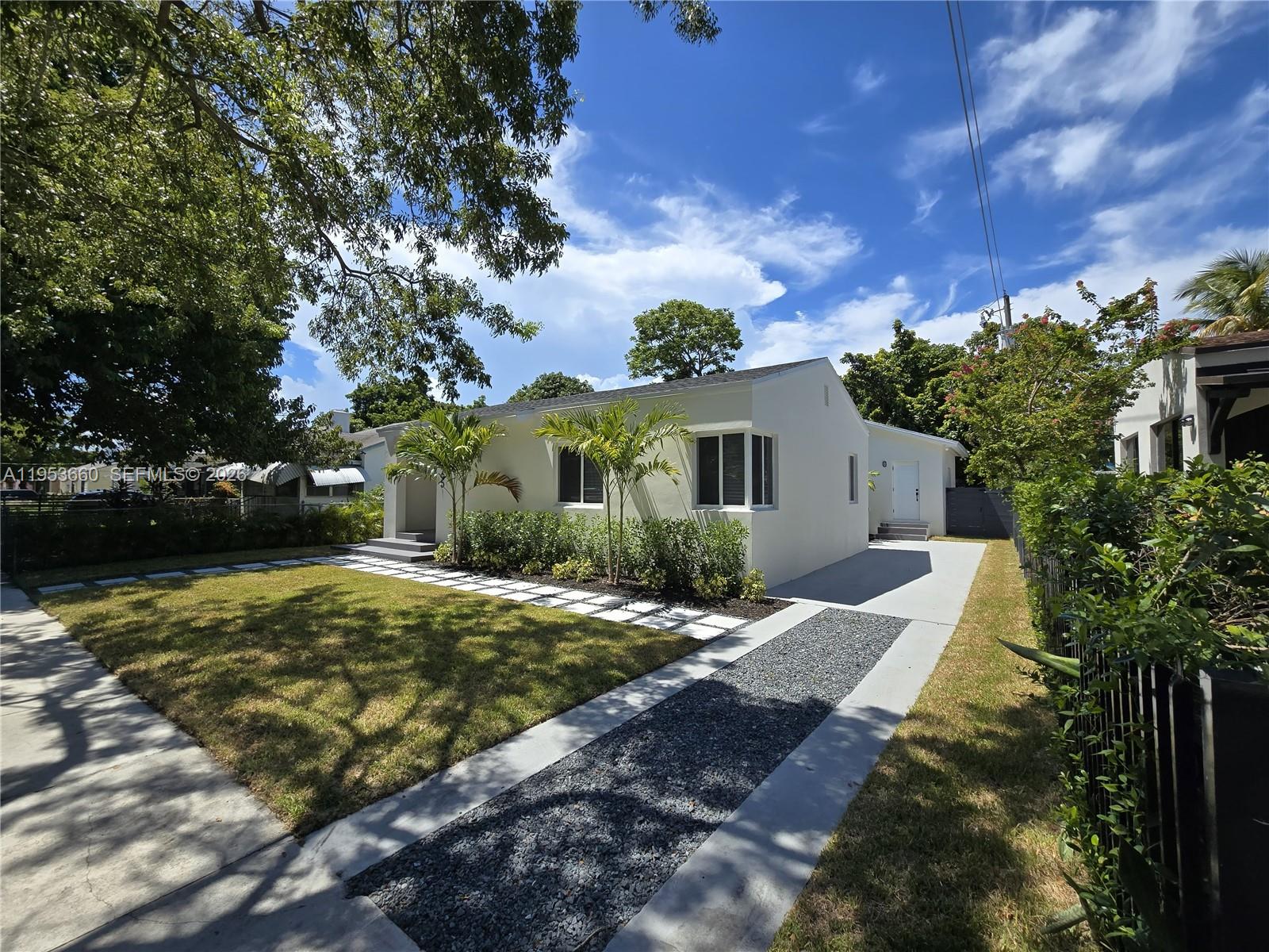 765 Northwest 45th Street Miami, FL 33127 - Photo 4 of 46 a front view of house with yard and trees around