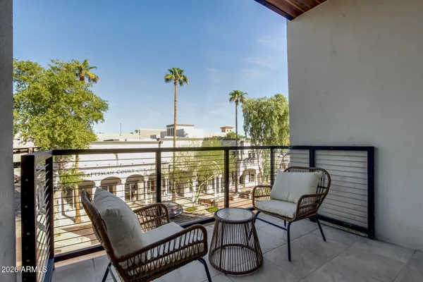 a view of a chairs and table in patio
