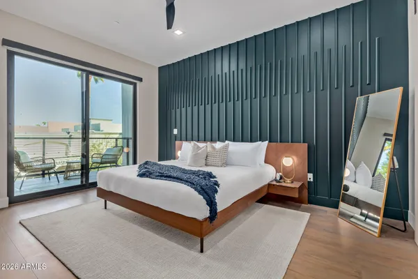 a spacious bedroom with a bed and large window