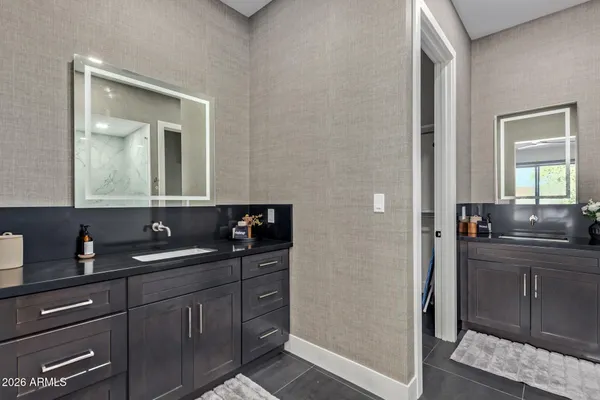 a bathroom with a double vanity sink and mirror
