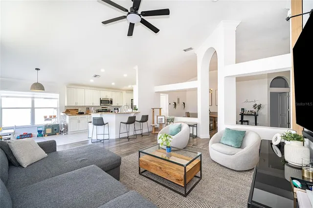 a living room with furniture and a chandelier