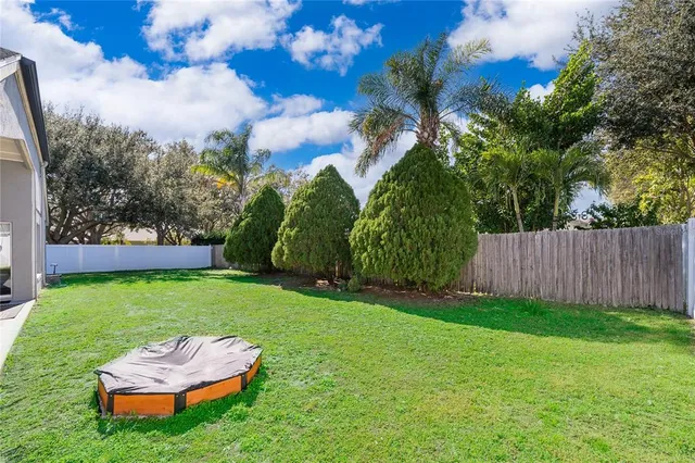 an aerial view of a house with a yard and mountain