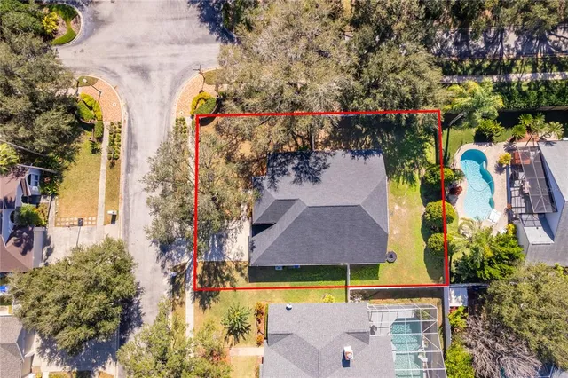 an aerial view of residential houses with outdoor space and swimming pool