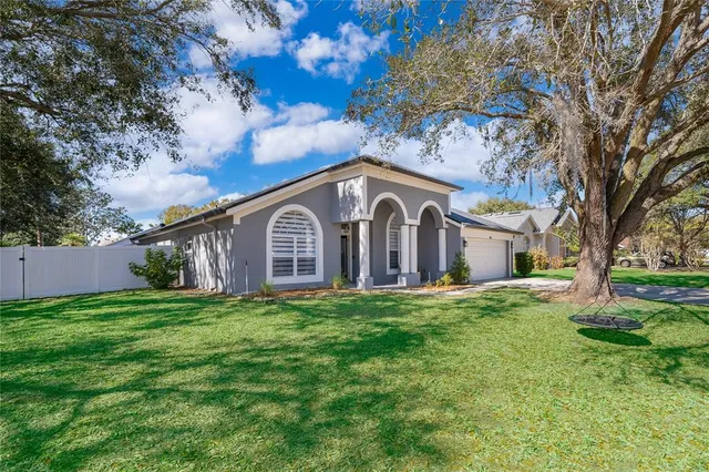 a front view of house with yard and green space
