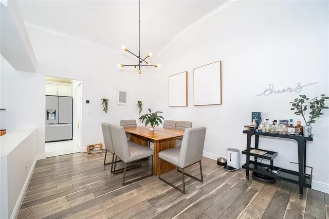 a view of a livingroom with furniture and a dining table