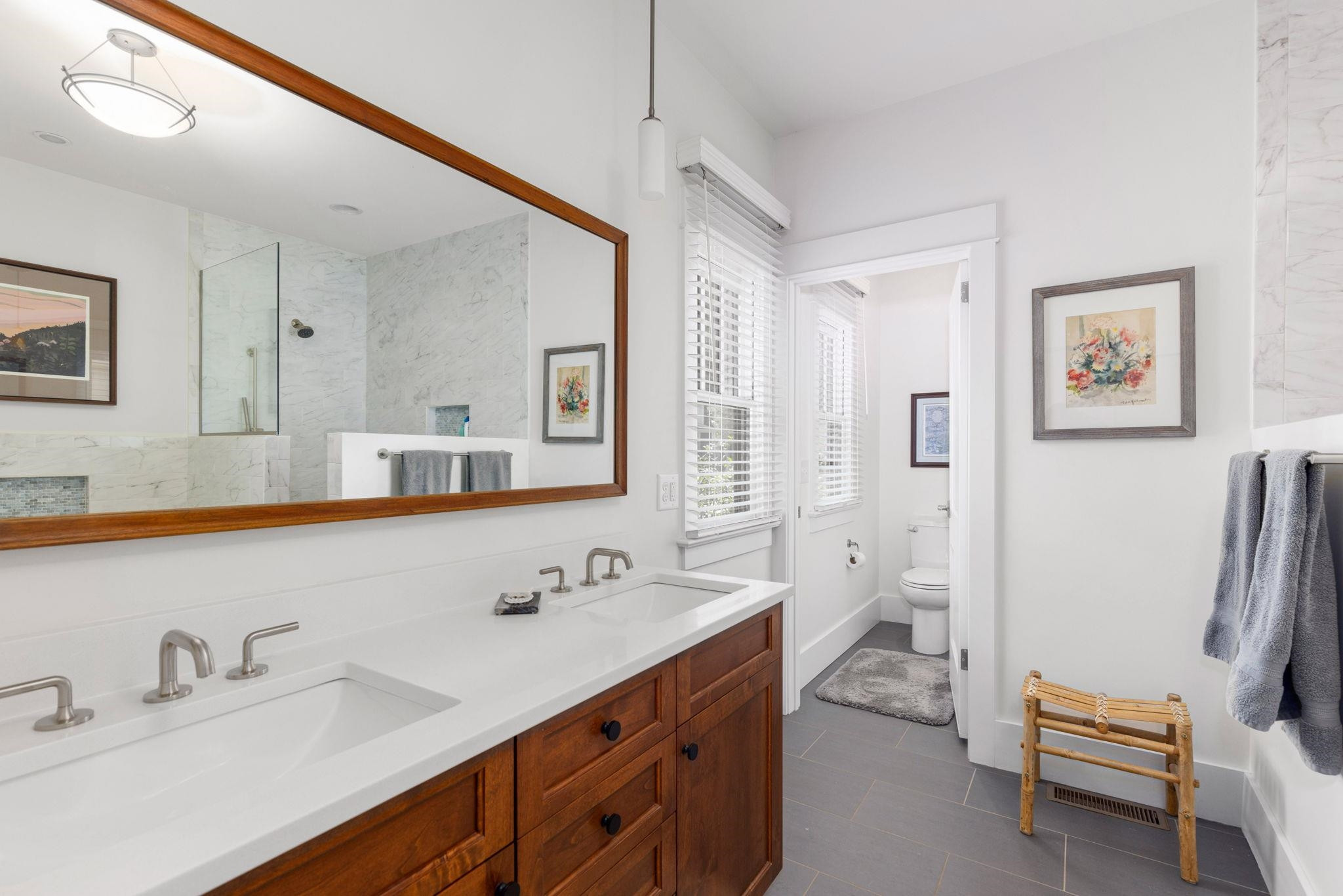1610 Bickett Boulevard Raleigh, NC 27608 - Photo 28 of 44 a spacious bathroom with a double vanity sink a mirror and a shower