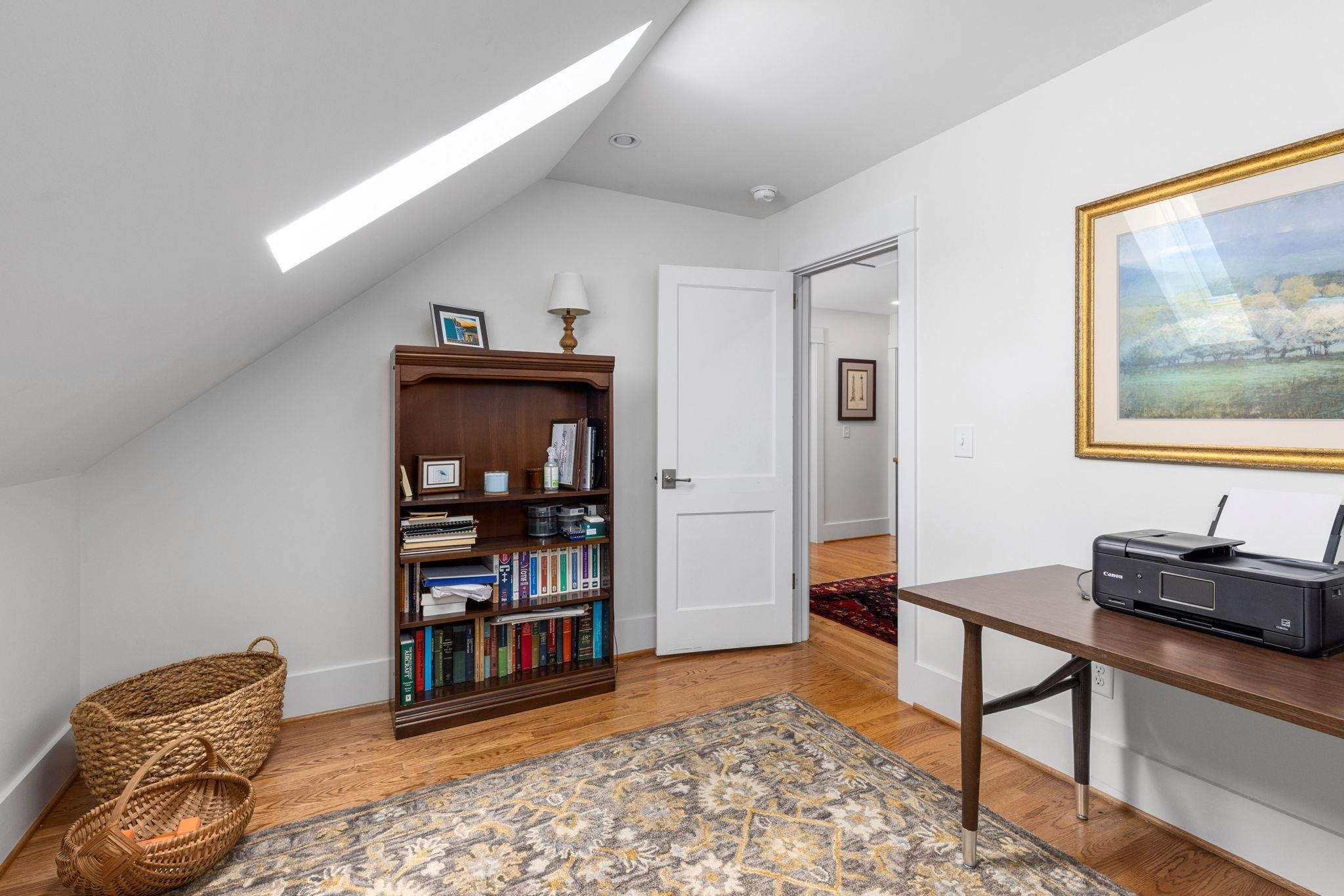 1610 Bickett Boulevard Raleigh, NC 27608 - Photo 30 of 44 a living room with furniture and a book shelf