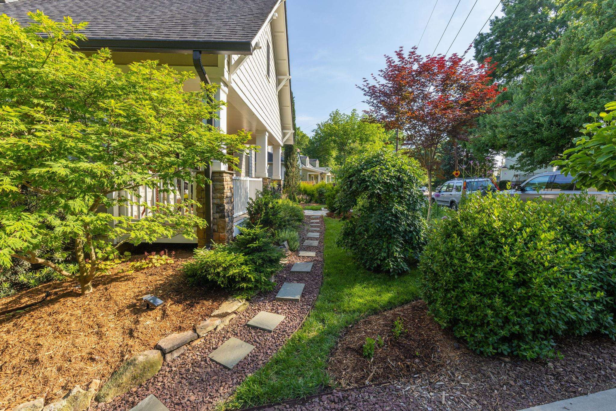 1610 Bickett Boulevard Raleigh, NC 27608 - Photo 3 of 44 a view of a yard with plants and large trees