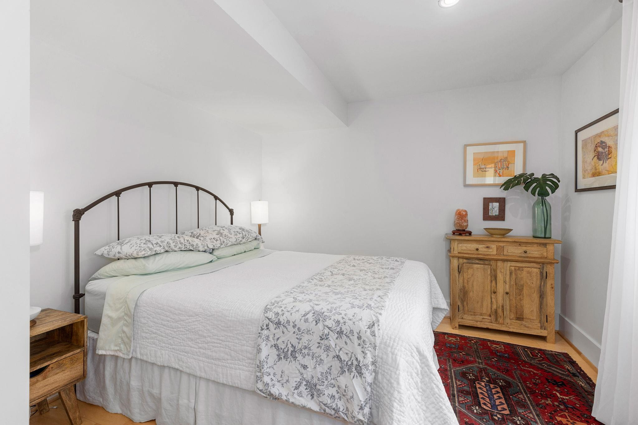 1610 Bickett Boulevard Raleigh, NC 27608 - Photo 40 of 44 a bedroom with a bed and a chandelier