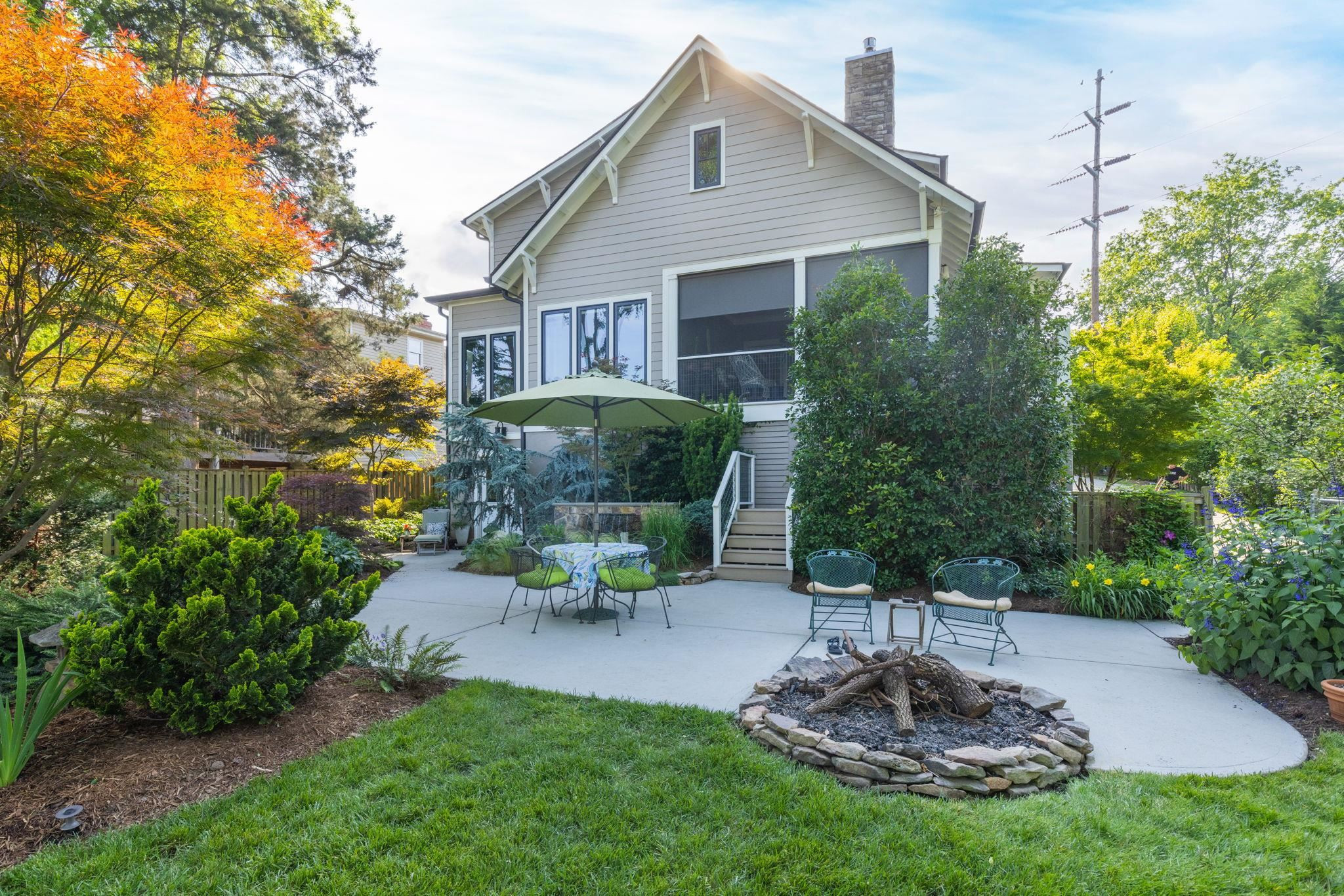 1610 Bickett Boulevard Raleigh, NC 27608 - Photo 5 of 44 a view of a patio with table and chairs potted plants and a tree