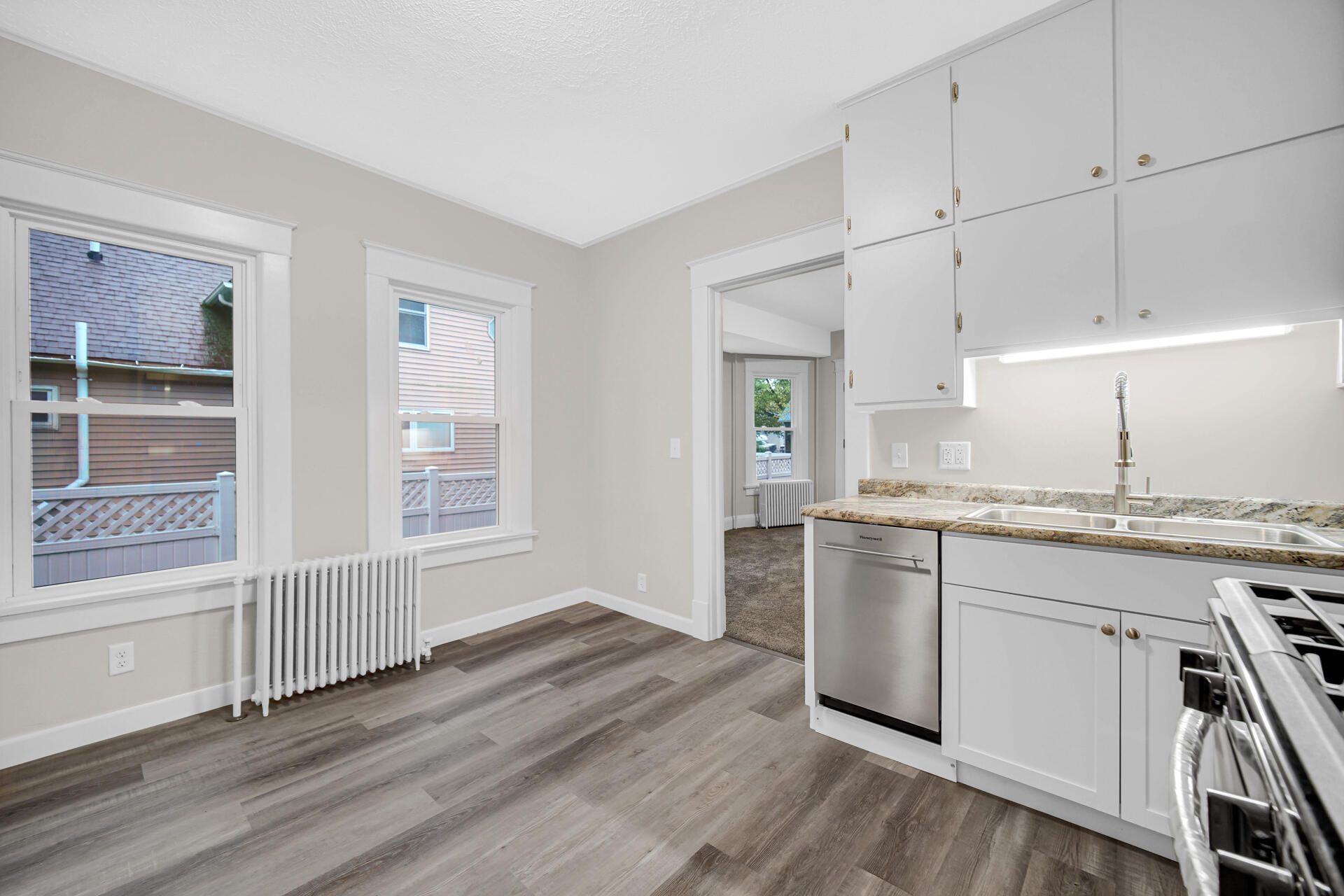 411 E Street La Porte, IN 46350 - Photo 16 of 33 a kitchen with granite countertop white cabinets and white appliances