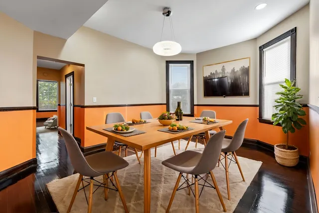 a view of a dining room with furniture and wooden floor