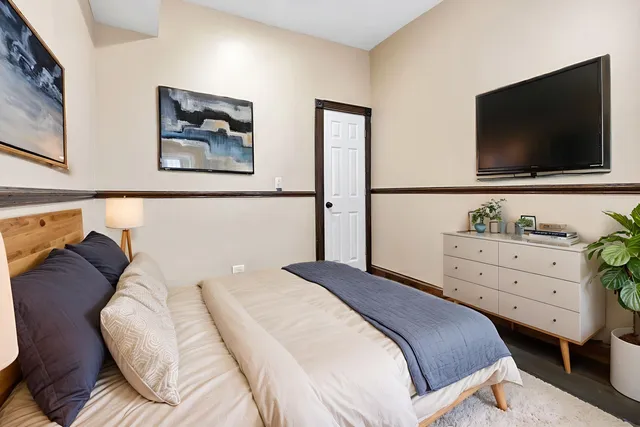 a bedroom with a bed and a flat screen tv