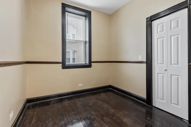 a view of a small space with wooden floor and a window
