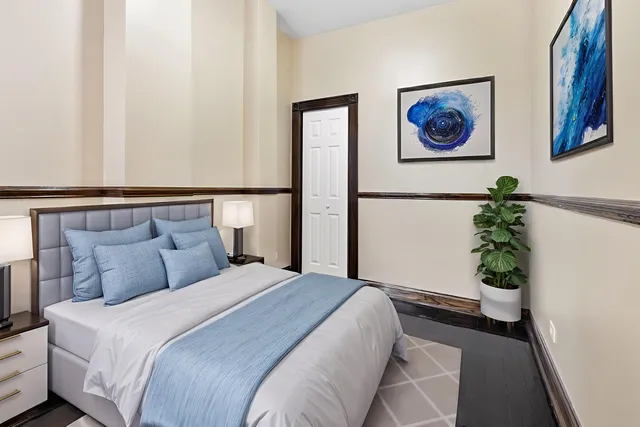 a bedroom with bed and a potted plant