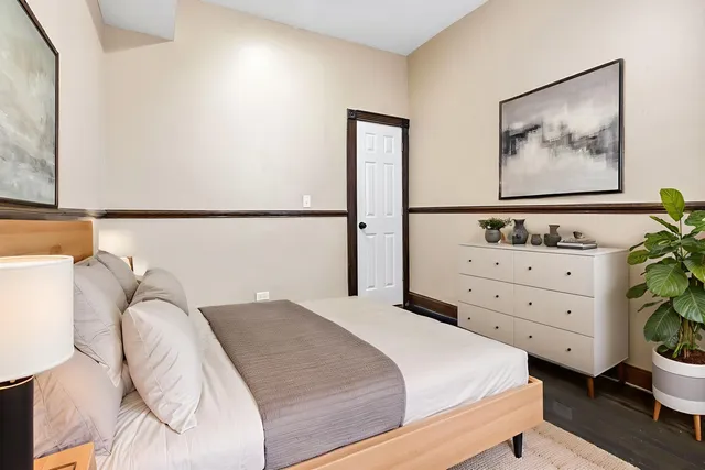 a bedroom with a bed and a dresser