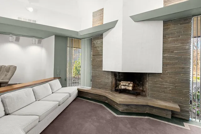 a living room with furniture and a lamp