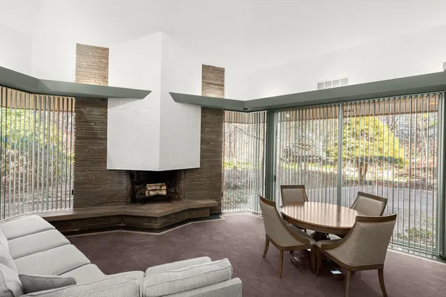 a living room with furniture and large windows