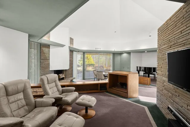 a room with a table chairs and a workspace