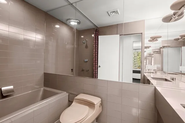 a bathroom with a sink shower and a mirror