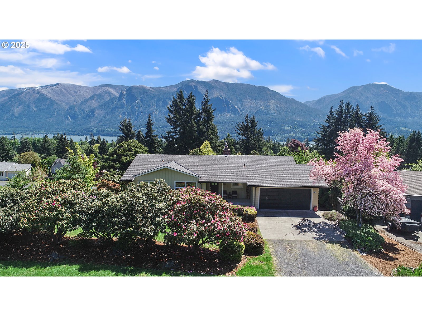 101 Allen Street Carson, WA 98610 - Photo 7 of 48 a view of a house with a yard and a lot of flower plants